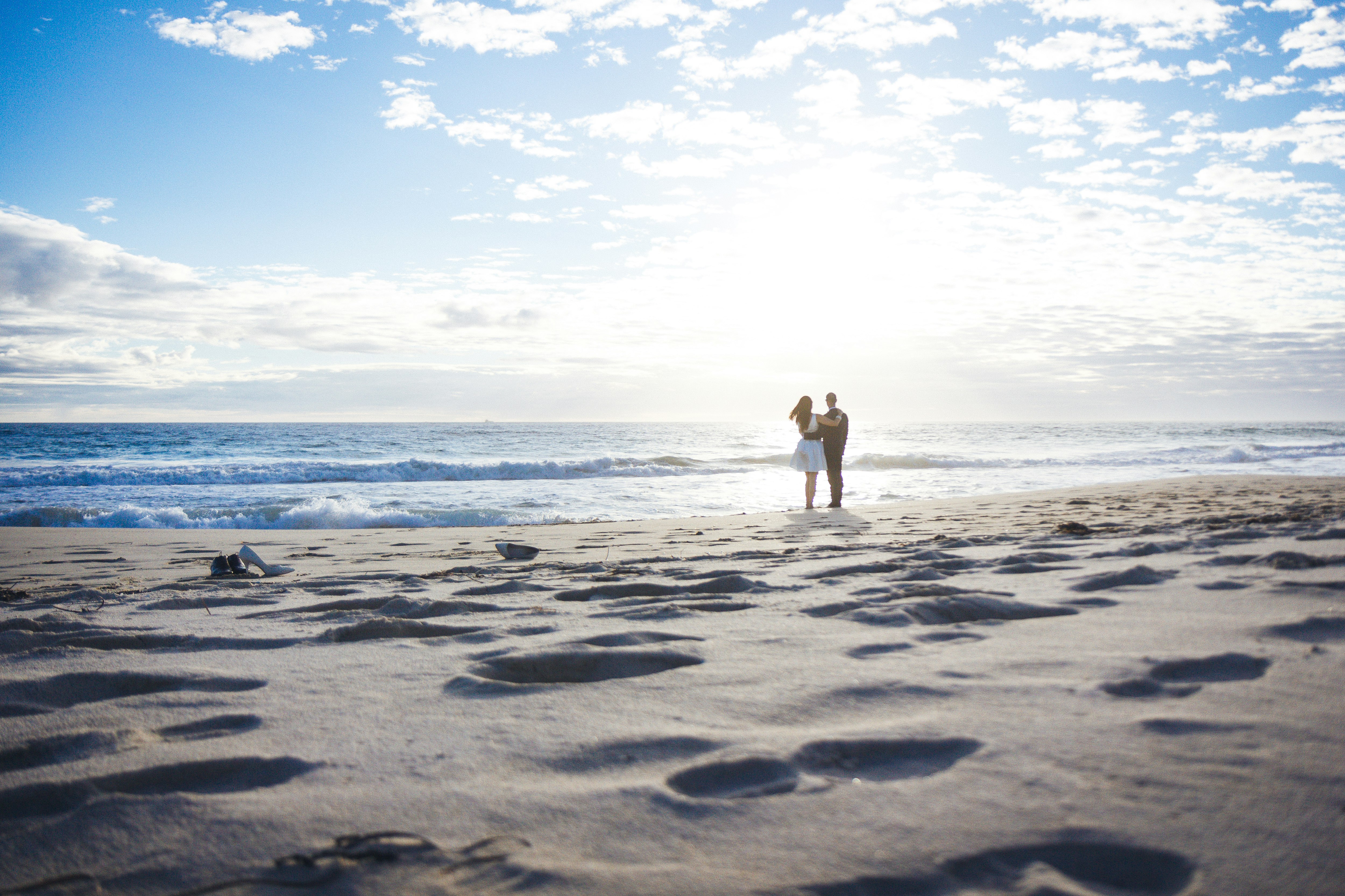 man and woman standing on shore